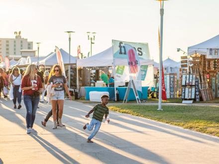Festival tents and shoppers along the Gulf Coast